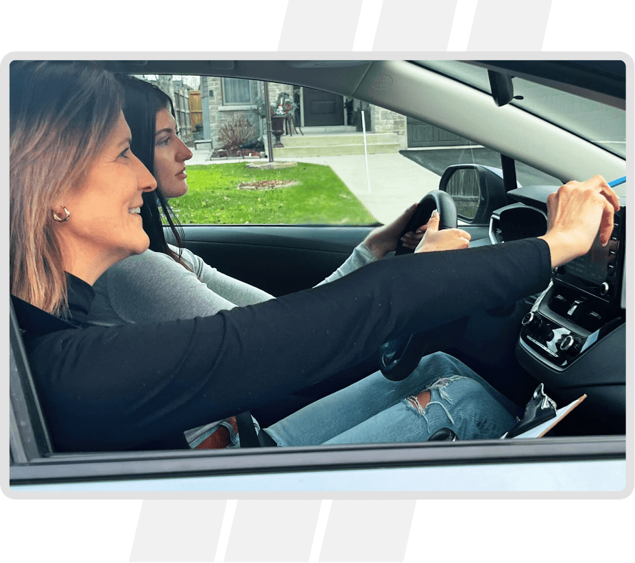 2 Two women in a car driving on the road.